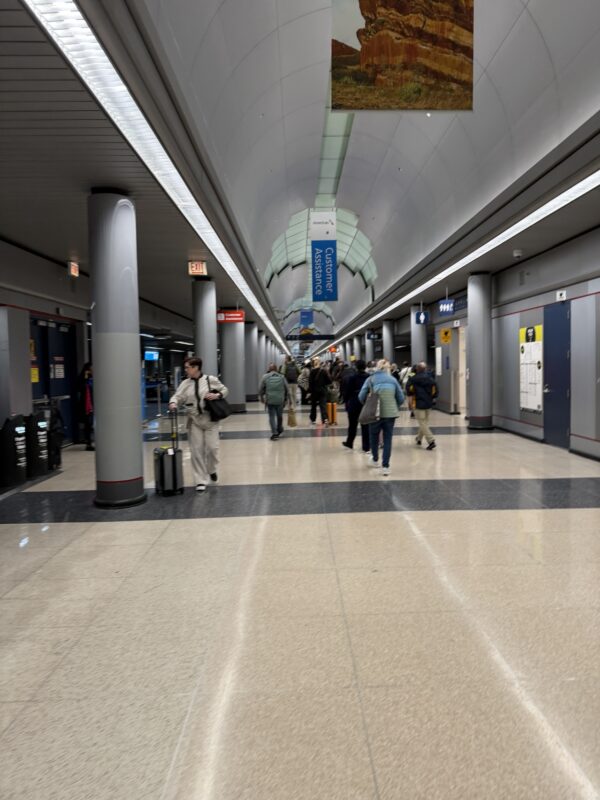 a group of people walking in a hallway