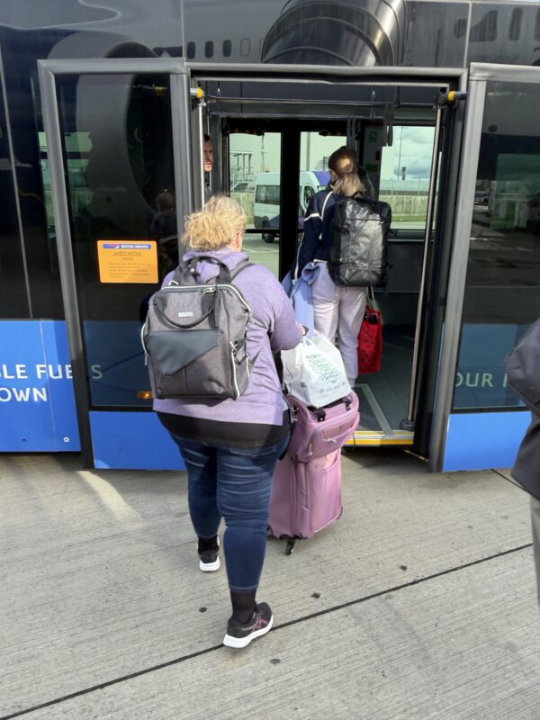 a group of people with luggage entering a bus