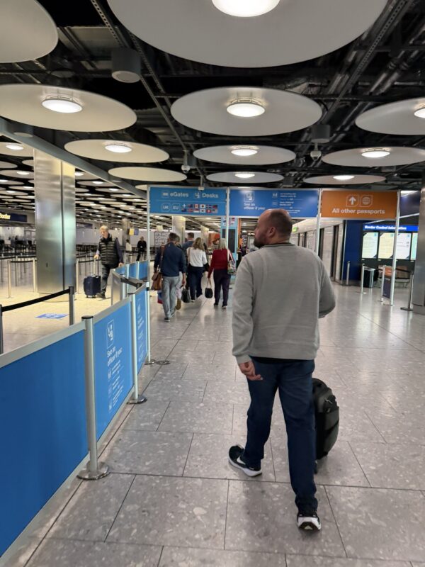 a man with a suitcase in a airport