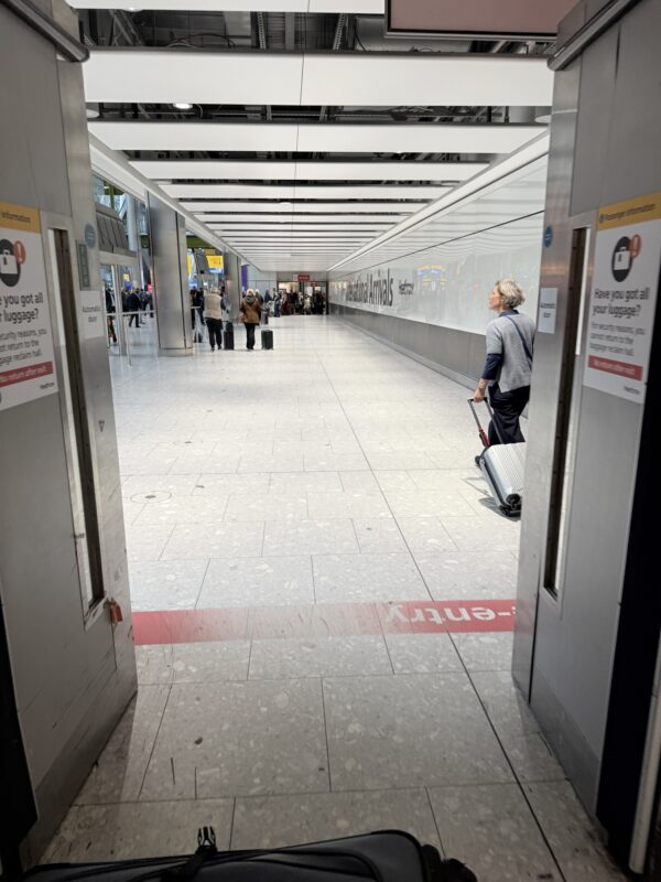 a person with luggage in a hallway