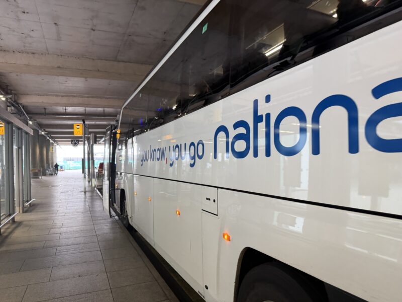 a white bus parked in a station