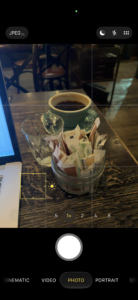 a cup of coffee and a jar of sugar on a table
