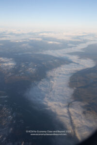 aerial view of a landscape with clouds and mountains