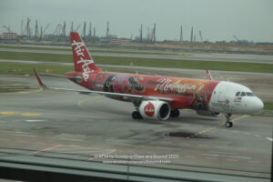 a red airplane on a runway