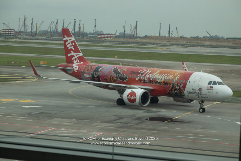 a red airplane on a runway