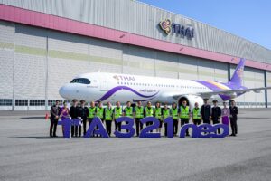 a group of people standing in front of a large airplane