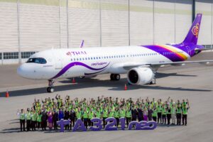 a group of people standing in front of a large airplane
