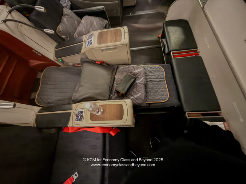 a seat with a bottle and a drink on it