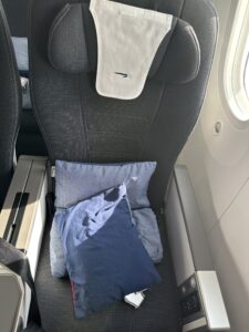 a seat with pillows and a towel on it