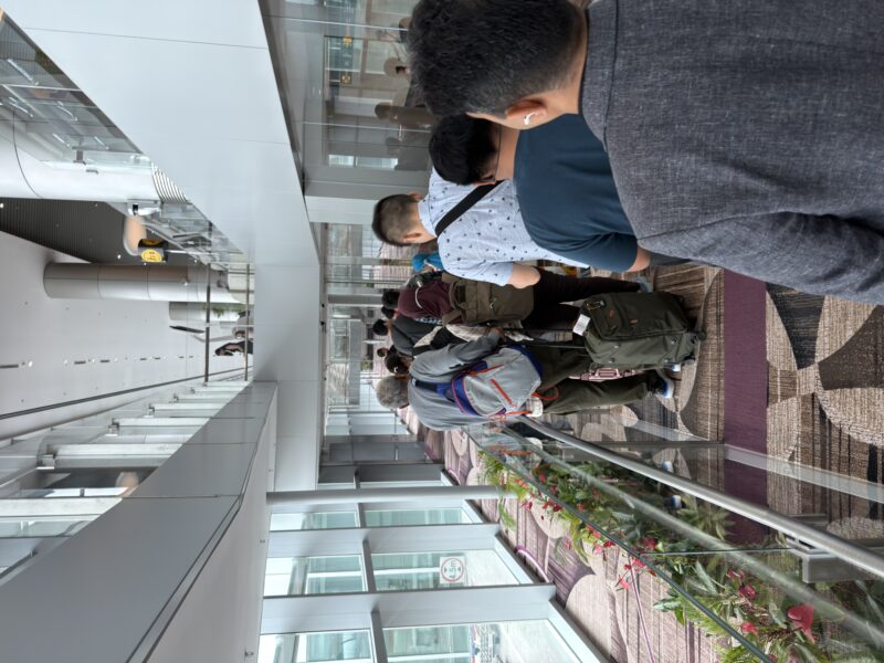 a group of people walking down a hallway