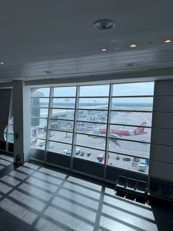 a large window with a plane in the background