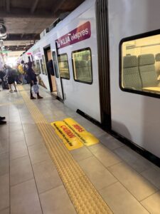 a train with people standing in a station