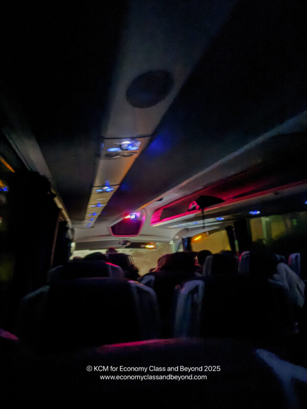 a group of people sitting in a bus