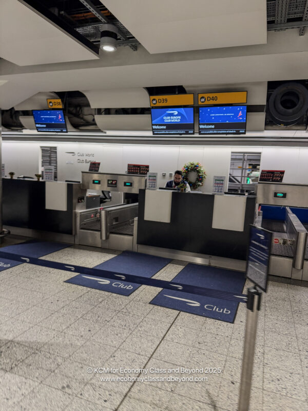 a man standing at a counter in a airport