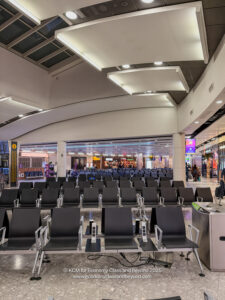 a large airport terminal with rows of chairs