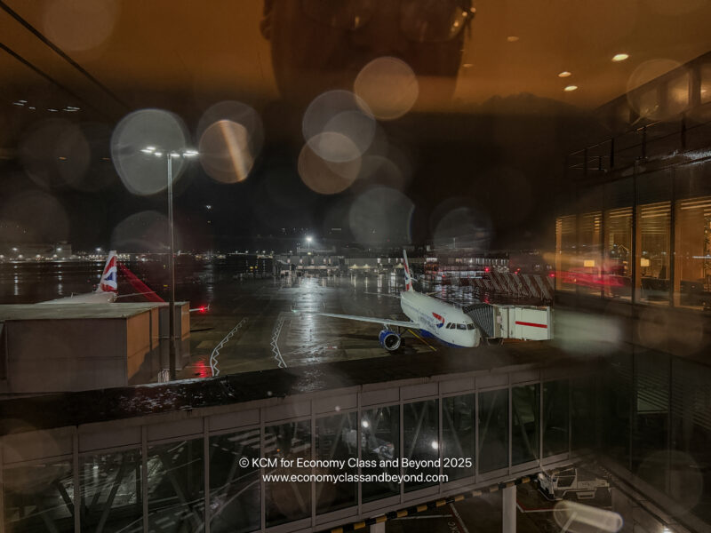 an airplane parked on a runway at night