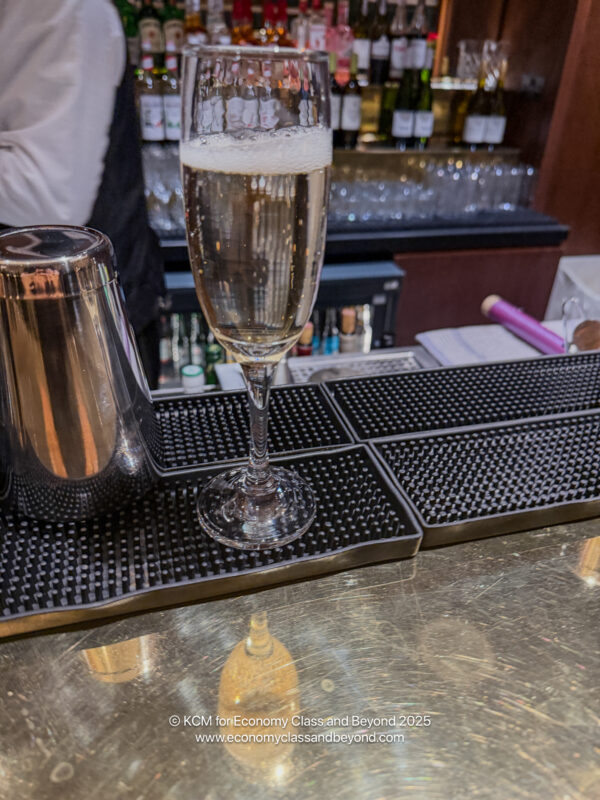 a glass of champagne on a bar
