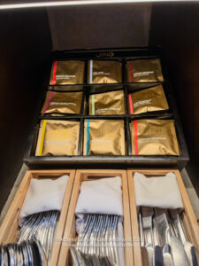 a group of silverware in wooden boxes