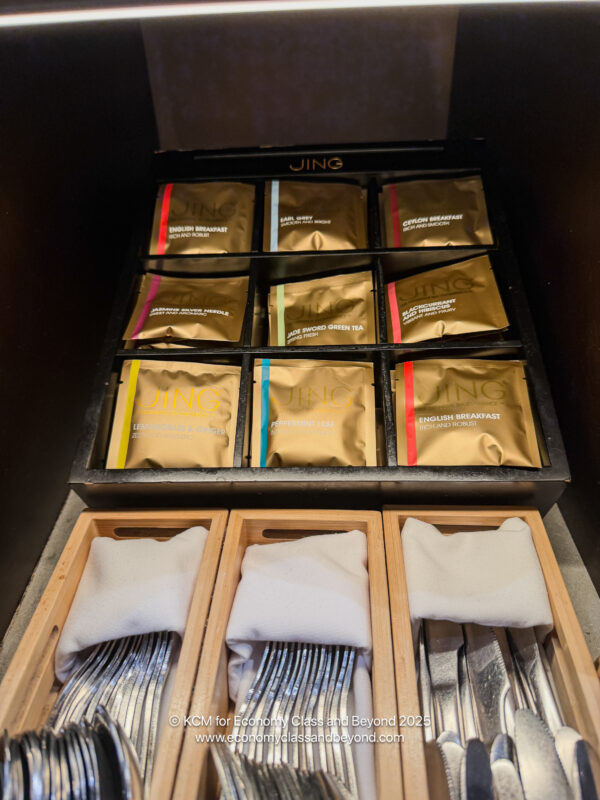 a group of silverware in wooden boxes