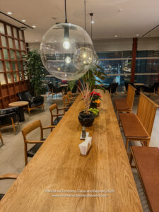 a table with chairs and a large clear balloon from the ceiling