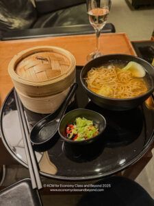 a bowl of soup and noodles on a table