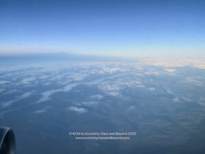 a view of clouds and blue sky from an airplane
