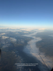 aerial view of a river and mountains from an airplane