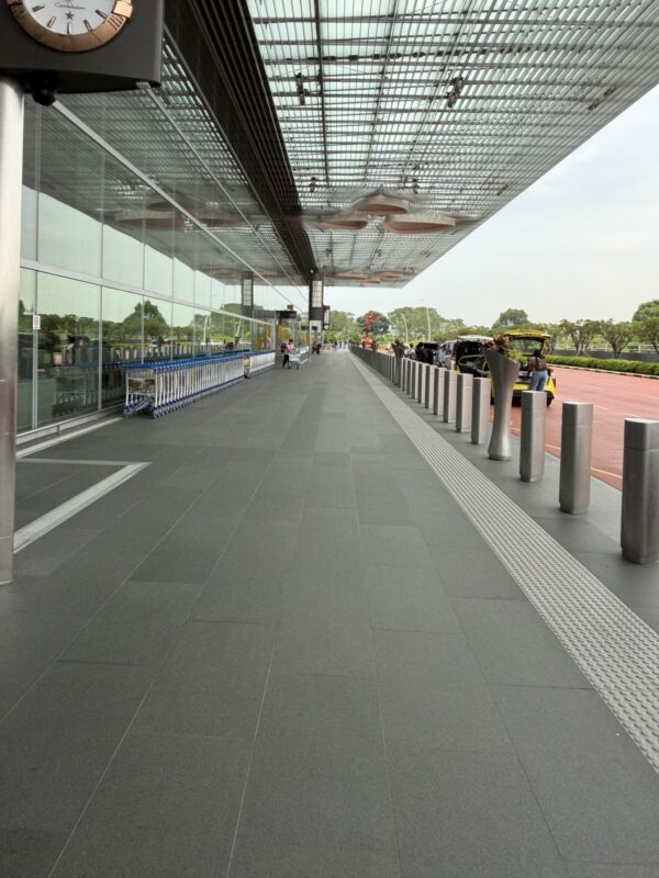 a building with a glass wall and a walkway