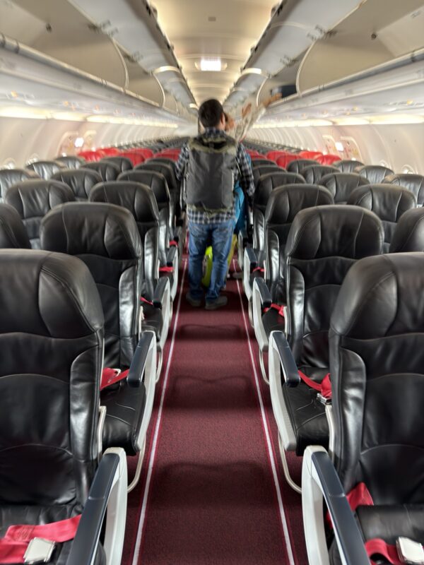 a man walking in an airplane