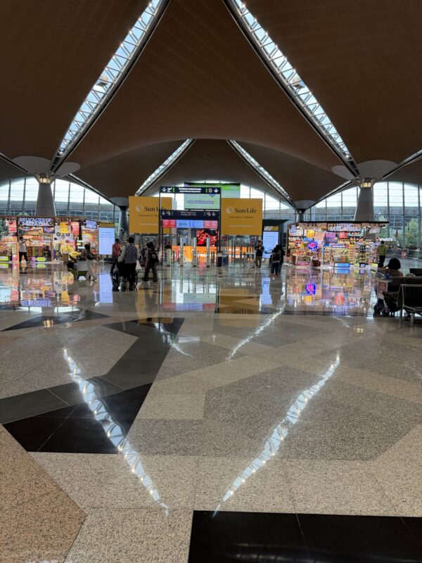 a large airport with people walking in the middle