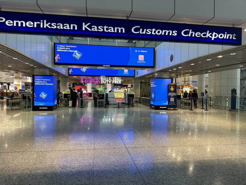 a large airport terminal with blue signs
