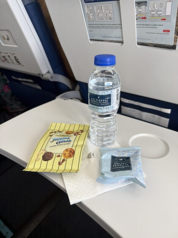 a bottle of water and a packet of candy on a table