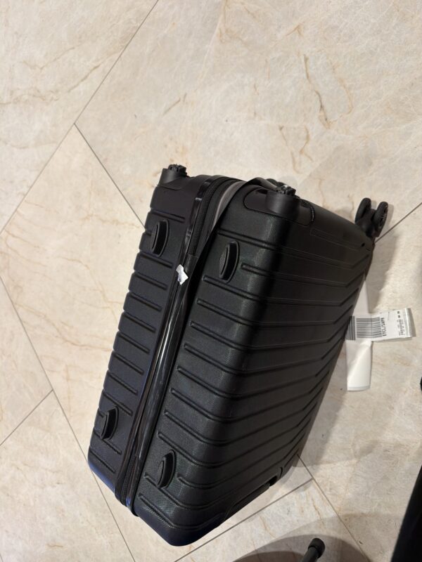 a black suitcase on a tile floor