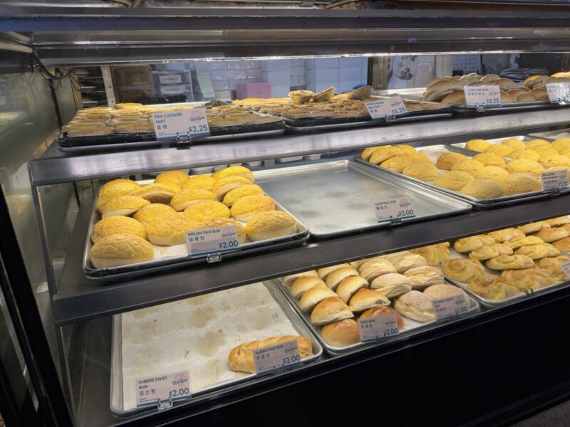 a display case with trays of pastries