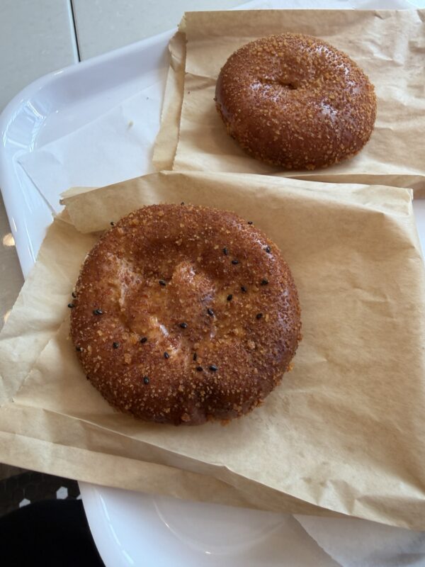 two bagels on paper on a tray