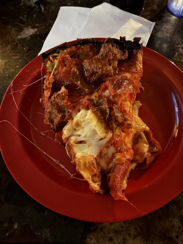 a slice of pizza on a red plate