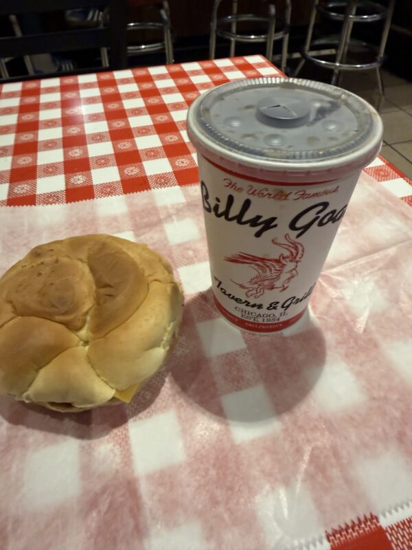 a hamburger and a drink on a table