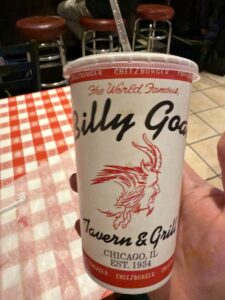 a hand holding a cup of hotdog