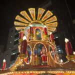 a lighted structure with a santa claus on top