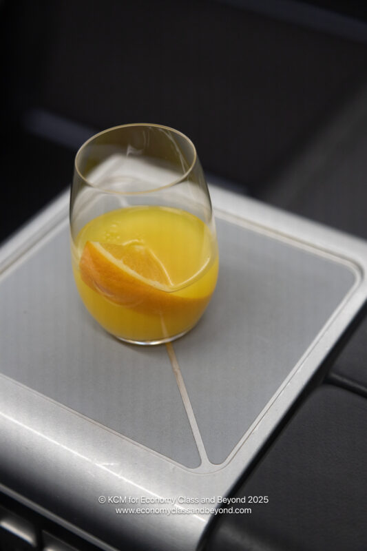 a glass of orange juice on a table