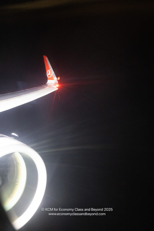 a plane wing with a red and white tail
