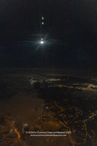 a moon over a city at night