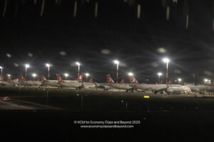 a row of airplanes at night