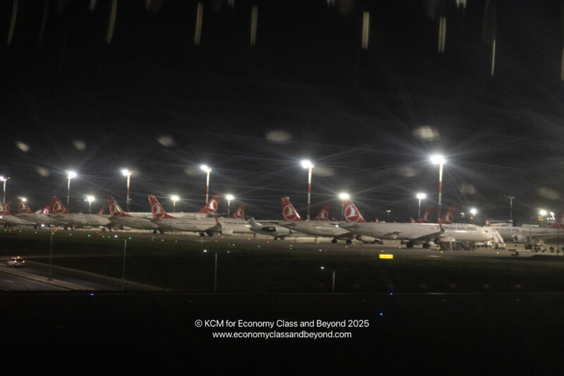 a row of airplanes at night