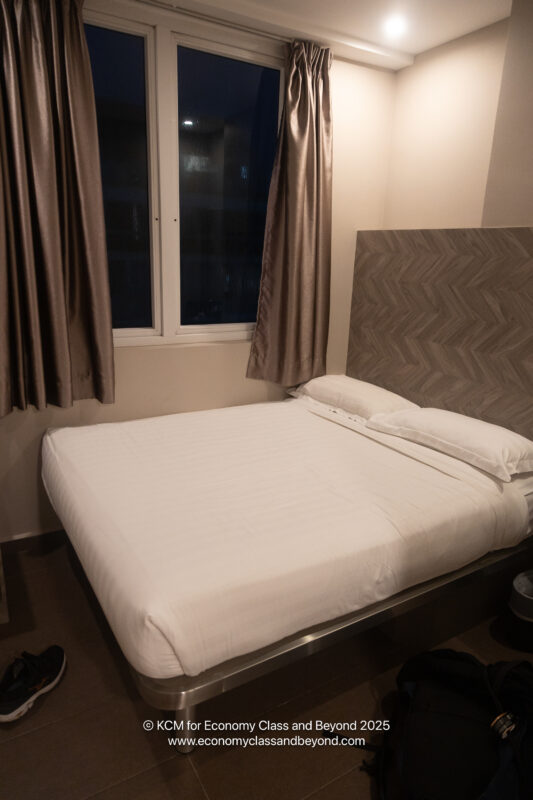 a bed with a headboard and a window