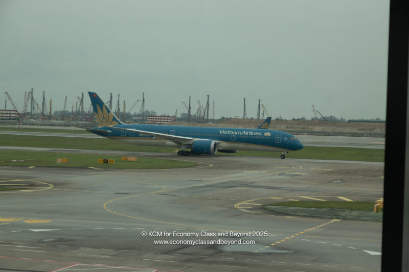a blue airplane on a runway