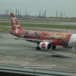 a red airplane on a runway