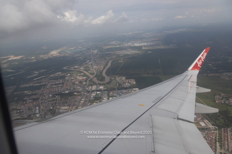 an airplane wing and a city