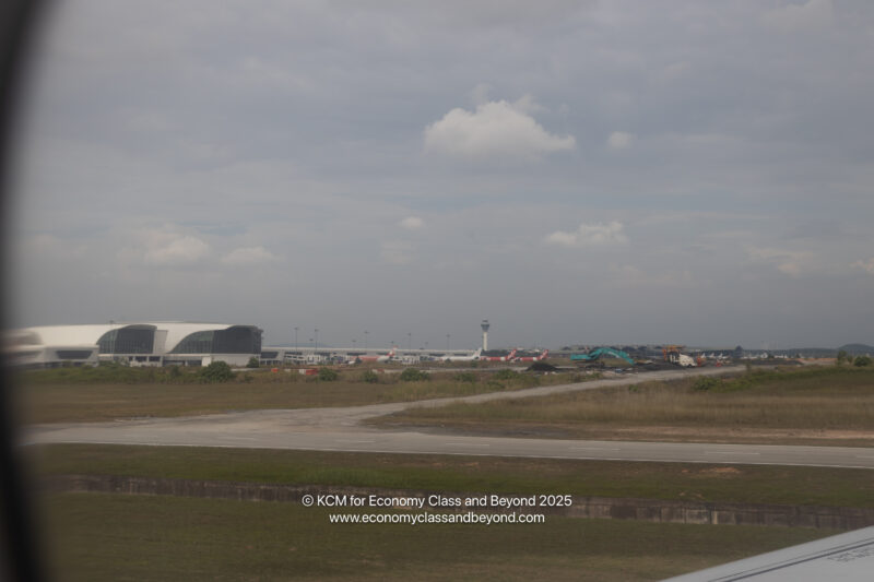 a runway with planes in the background