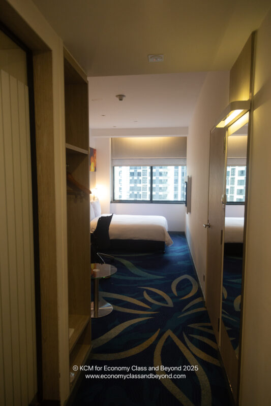 a room with a bed and a bookcase